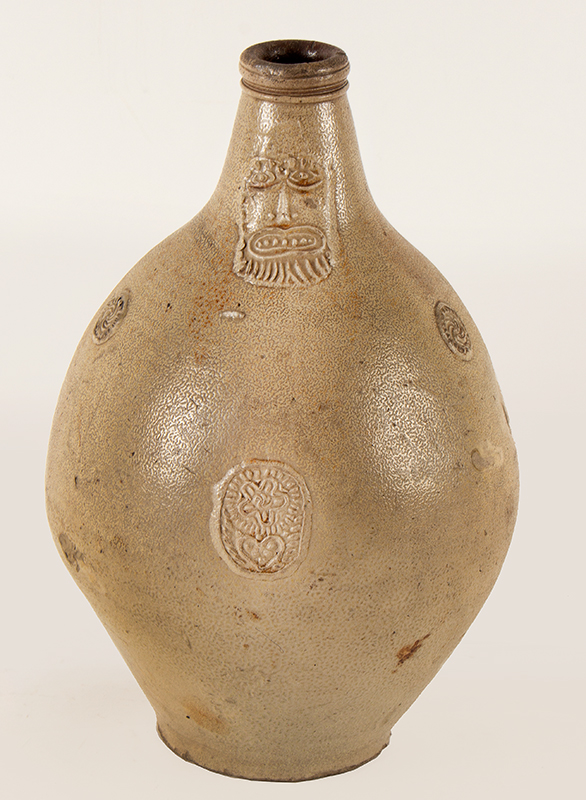 Antique Salt Glazed Stoneware Ovoid Jug, Bellarmine Graybeard 
Probably Frechen, Germany, 17th Century
Applied mask and three medallions, tooled spout and ribbed handle, entire view 1