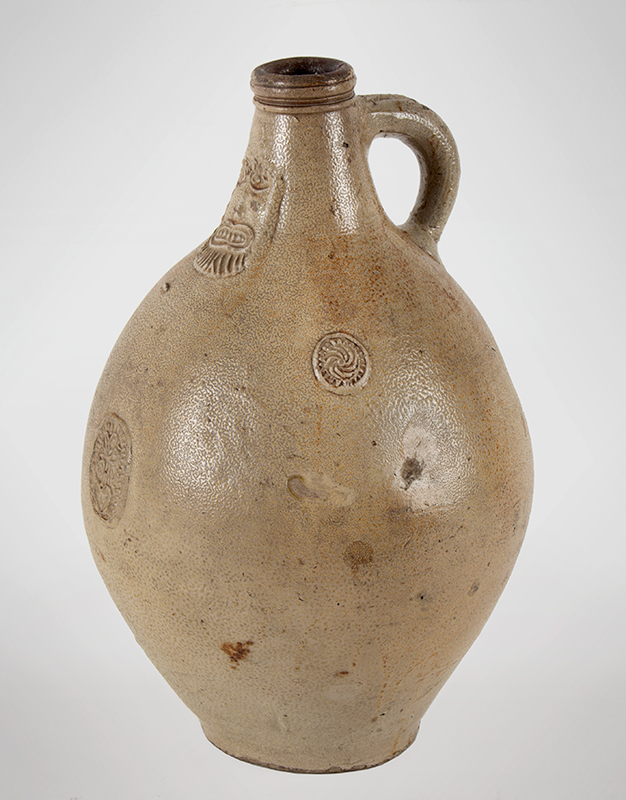 Antique Salt Glazed Stoneware Ovoid Jug, Bellarmine Graybeard 
Probably Frechen, Germany, 17th Century
Applied mask and three medallions, tooled spout and ribbed handle, entire view 2