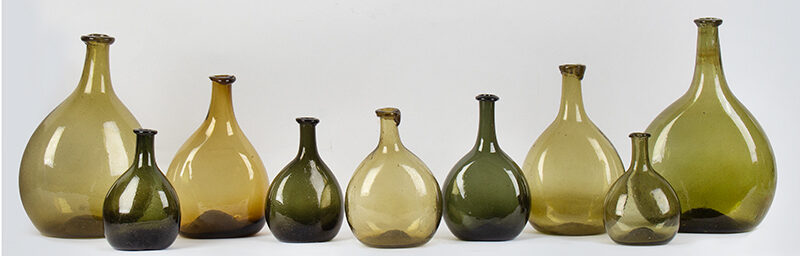 American Free-Blown Chestnut Bottles, Collection of 9, Shades of Green / Amber